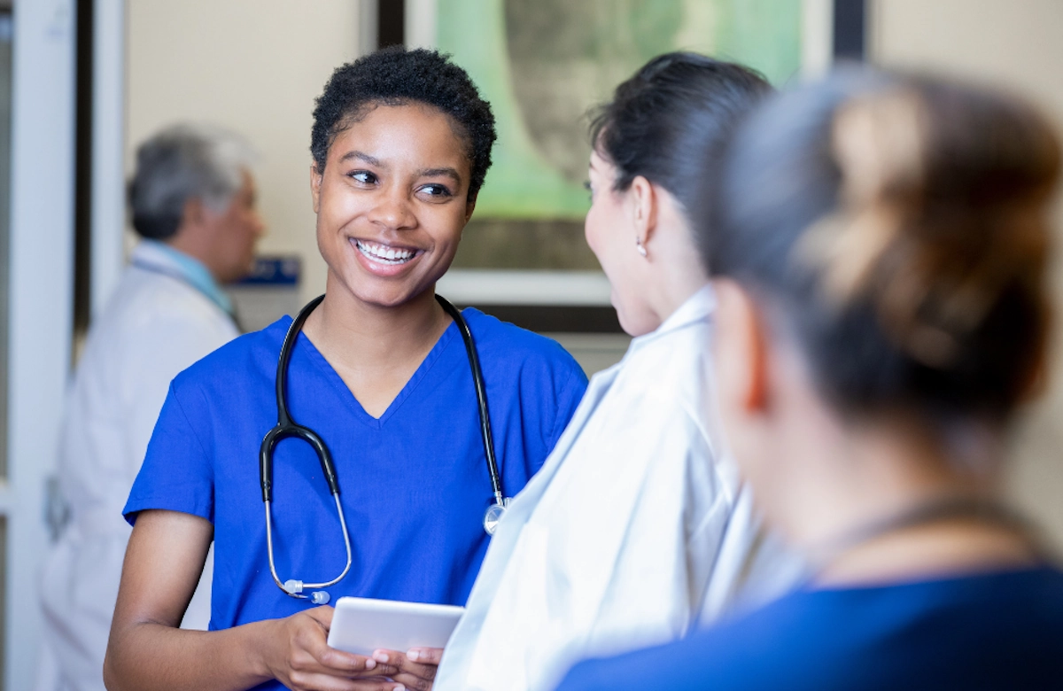 Smiling healthcare worker talking with a coworker